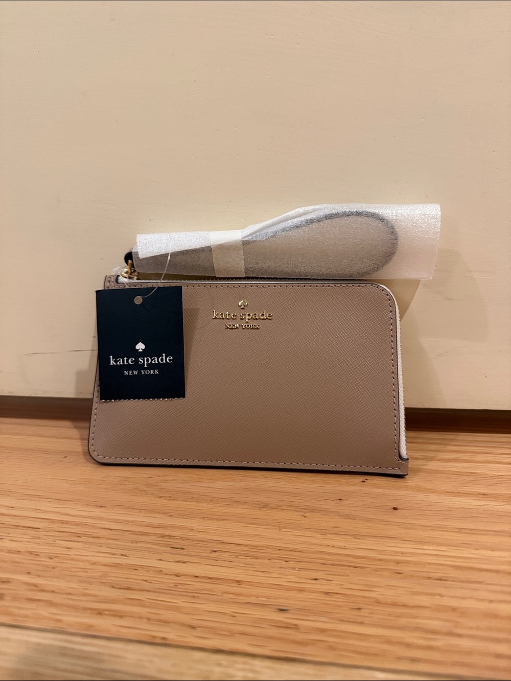 kate spade taupe beige Saffiano wristlet with gold logo